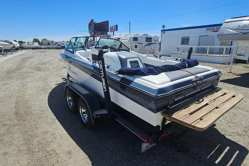Slide: The Image of 2000 Centurion Sport Bowrider boat on trailer in outdoor sales lot. - 4