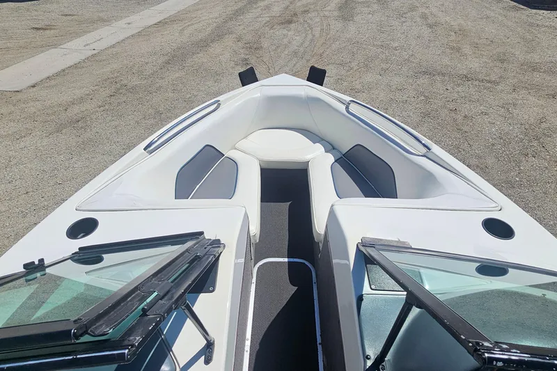 Slide: The Image of 2000 Centurion Sport Bowrider boat interior with white seating and open windshield. - 9