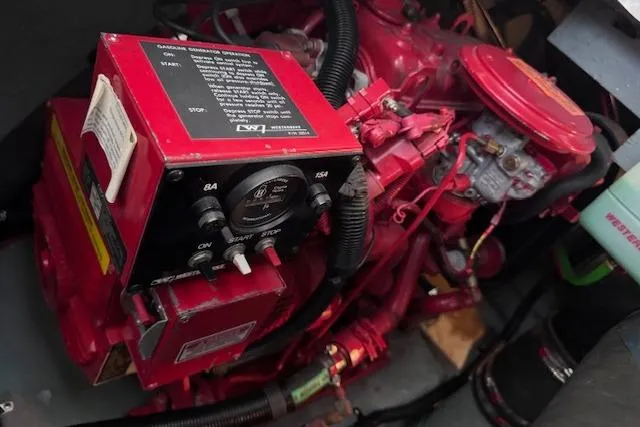 Slide: The Image of Engine compartment of a 1998 Sea Ray Sundancer 330, featuring a red marine engine. - 20