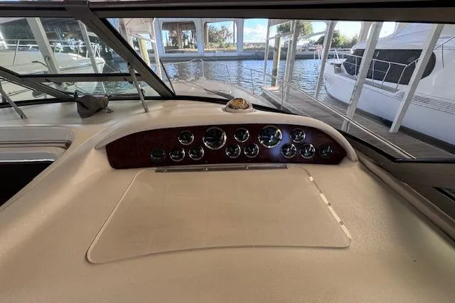 Slide: The Image of 1998 Sea Ray Sundancer 330 dashboard with gauges, docked at marina. - 30