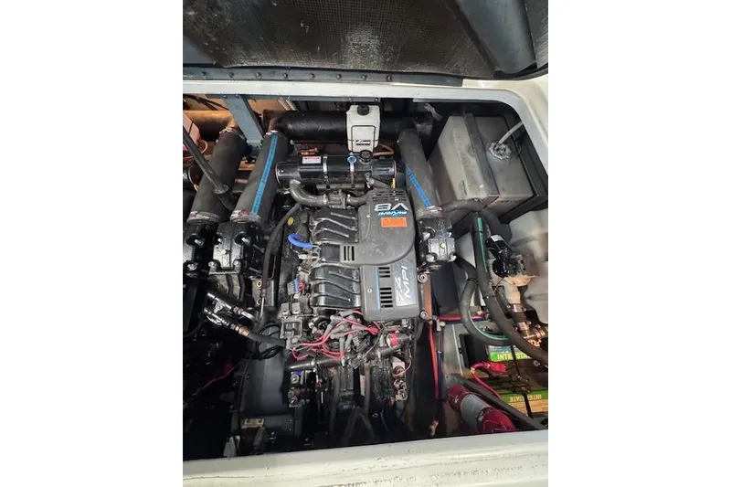 Slide: The Image of Engine compartment of a 1998 Sea Ray Sundancer 330 boat, showcasing mechanical components. - 32