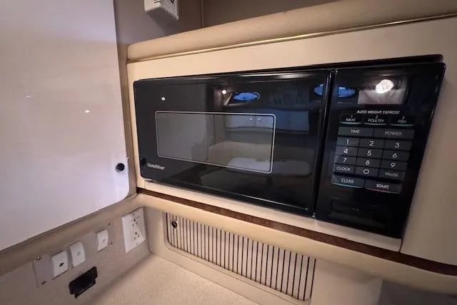 Slide: The Image of 1998 Sea Ray Sundancer 330 interior with built-in microwave and control panel. - 38