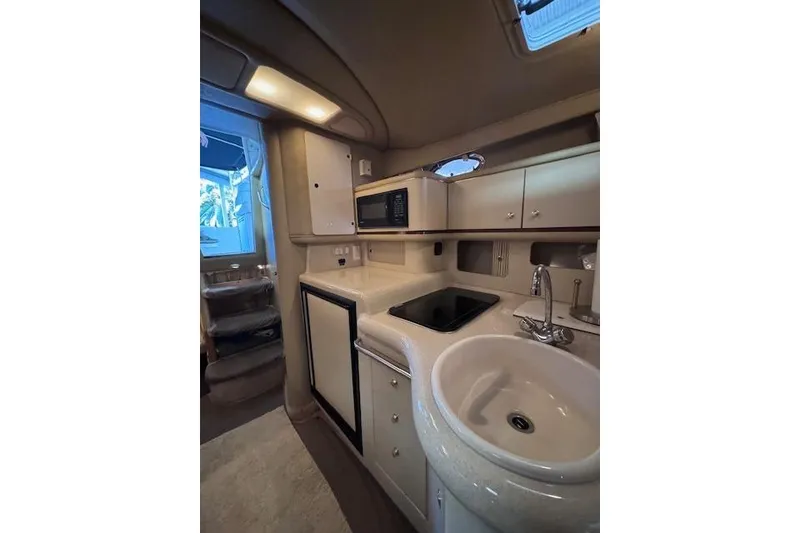 Slide: The Image of Interior of 1998 Sea Ray Sundancer 330 yacht kitchen with sink, stove, and microwave. - 40