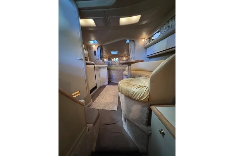 Slide: The Image of Interior of a 1998 Sea Ray Sundancer 330 yacht, featuring cozy seating and elegant design. - 41