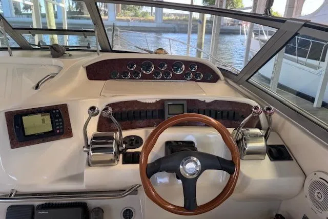 Slide: The Image of 1998 Sea Ray Sundancer 330 helm with wooden steering wheel and control panel. - 9