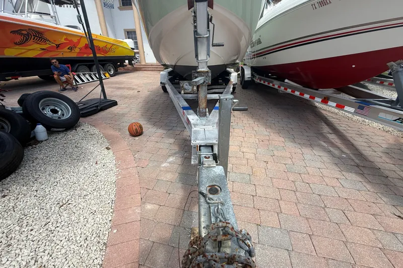 Slide: The Image of 2007 Boston Whaler 270 Outrage on trailer, surrounded by boats and equipment. - 16