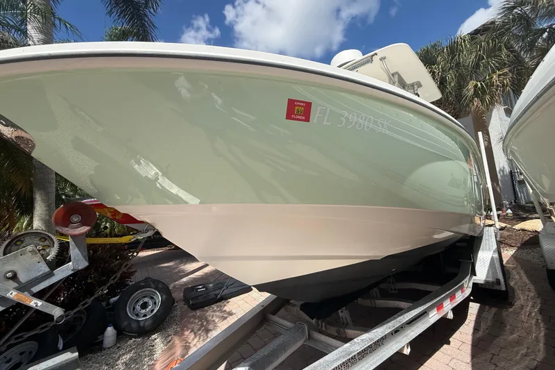 Slide: The Image of 2007 Boston Whaler 270 Outrage boat on trailer, sunny day, palm trees in background. - 20