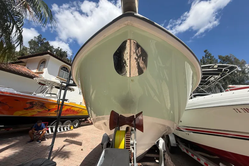 Slide: The Image of 2007 Boston Whaler 270 Outrage boat on trailer, sunny day, residential background. - 21