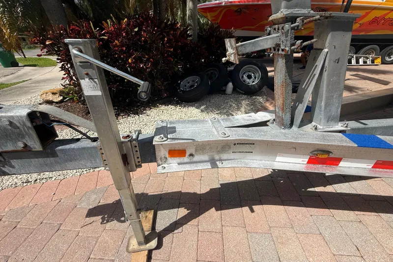 Slide: The Image of Trailer hitch and jack stand for 2007 Boston Whaler 270 Outrage on brick driveway. - 29