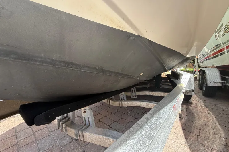 Slide: The Image of 2007 Boston Whaler 270 Outrage on trailer, showing hull and support structure. - 32