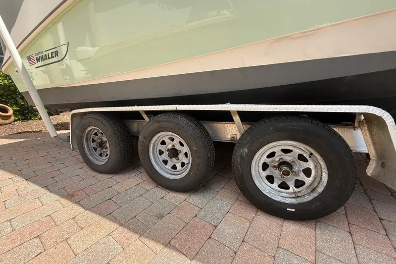 Slide: The Image of Trailer with Boston Whaler 270 Outrage boat, 2007 model, on brick pavement. - 36