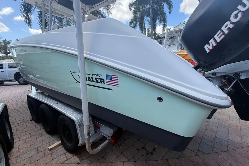 Slide: The Image of 2007 Boston Whaler 270 Outrage boat on trailer, displayed outdoors. - 4
