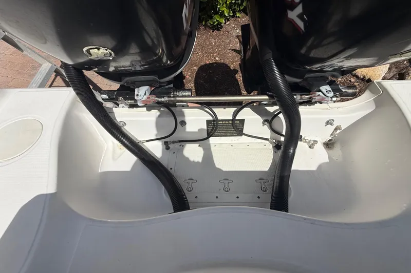 Slide: The Image of Boston Whaler 270 Outrage 2007 boat engine compartment with dual motors and cables. - 45