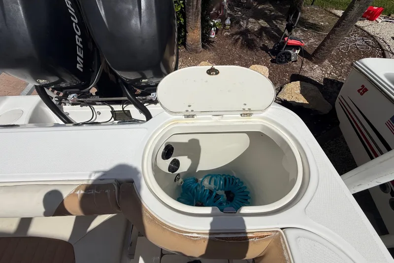 Slide: The Image of Open storage compartment on a 2007 Boston Whaler 270 Outrage boat with twin Mercury engines. - 47