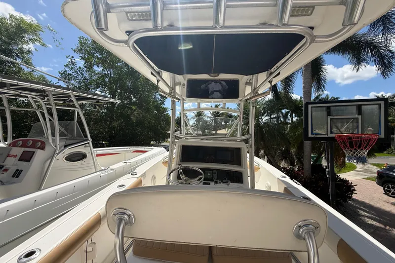 Slide: The Image of 2007 Boston Whaler 270 Outrage boat interior with steering console, parked outdoors. - 53