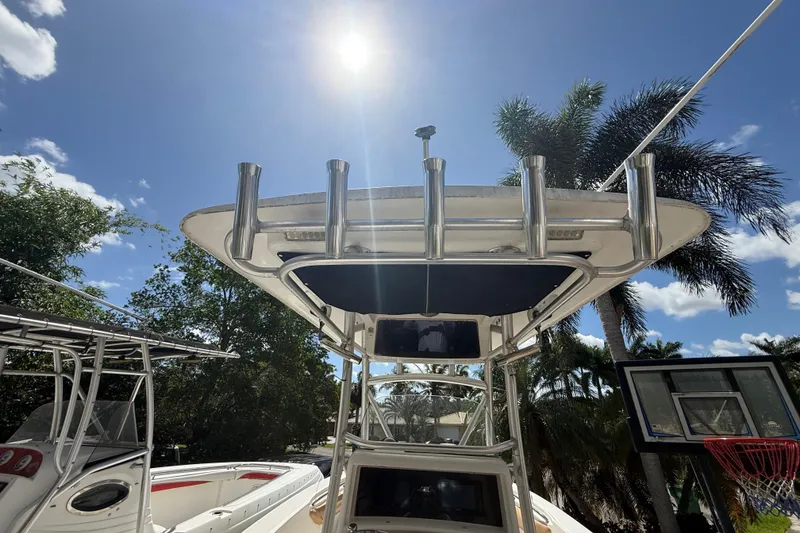 Slide: The Image of 2007 Boston Whaler 270 Outrage boat under sunny sky with palm trees. - 54
