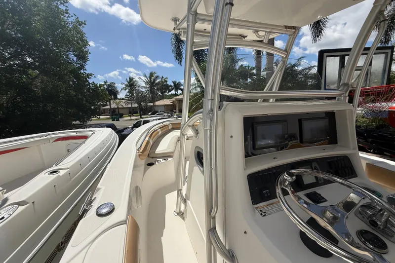 Slide: The Image of 2007 Boston Whaler 270 Outrage boat interior with steering wheel and navigation screens. - 57