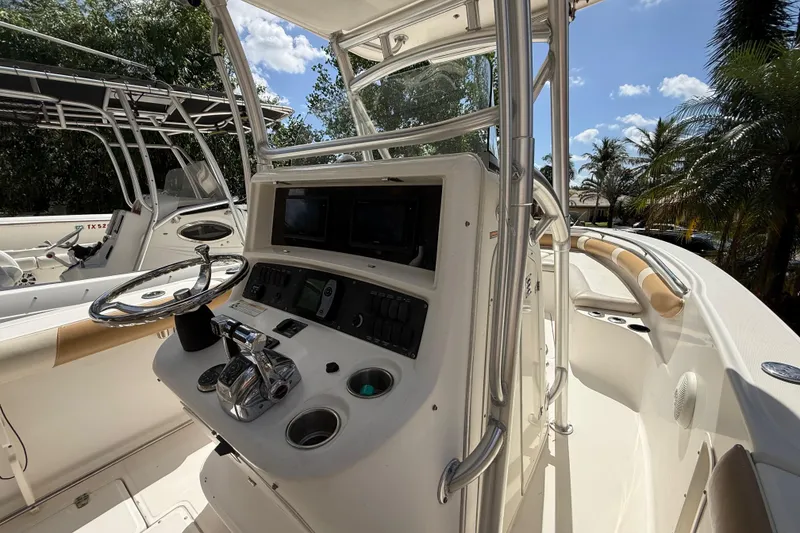 Slide: The Image of 2007 Boston Whaler 270 Outrage boat cockpit with steering wheel and control panel. - 60