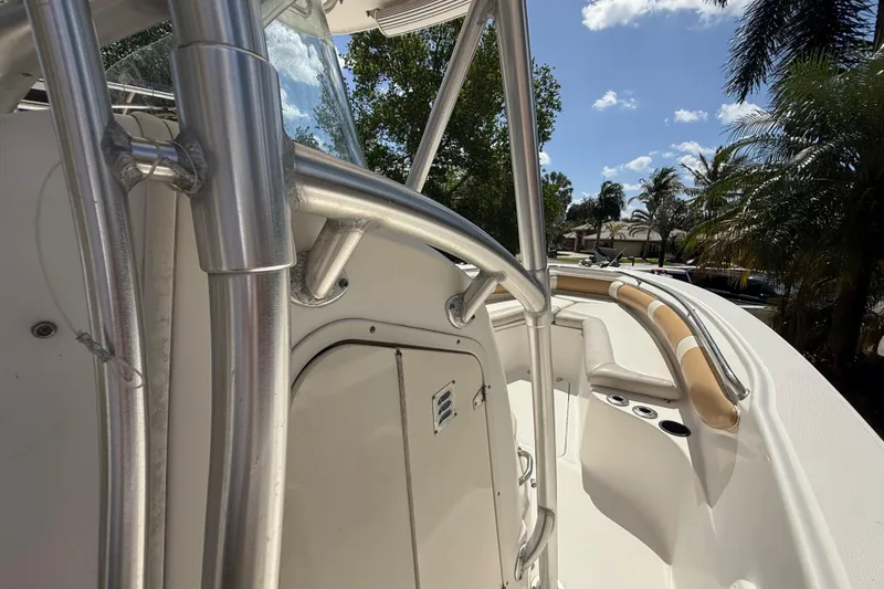 Slide: The Image of 2007 Boston Whaler 270 Outrage boat interior with metal railings and seating under sunny skies. - 61