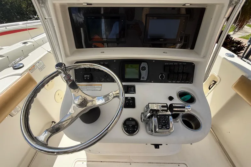 Slide: The Image of 2007 Boston Whaler 270 Outrage helm with steering wheel and control panel. - 62
