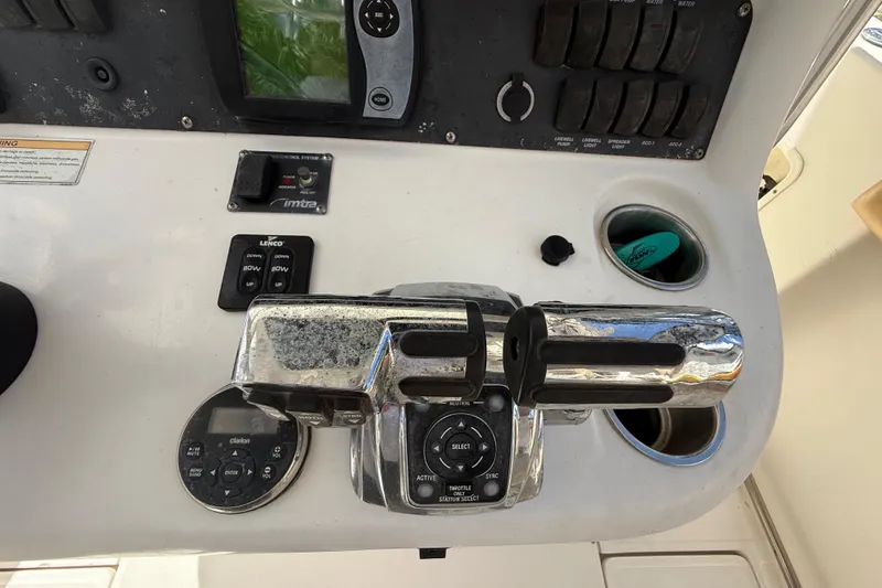 Slide: The Image of Control panel of a 2007 Boston Whaler 270 Outrage boat with throttle and switches. - 66