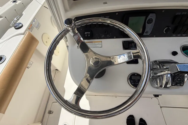 Slide: The Image of Steering wheel and controls of a 2007 Boston Whaler 270 Outrage boat. - 67