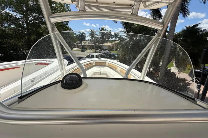 Slide: The Image of 2007 Boston Whaler 270 Outrage boat cockpit view with clear windshield and compass. - 68