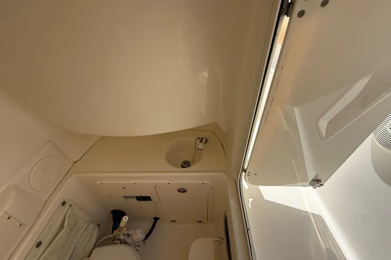 Slide: The Image of Interior view of 2007 Boston Whaler 270 Outrage boat's compact bathroom area. - 71