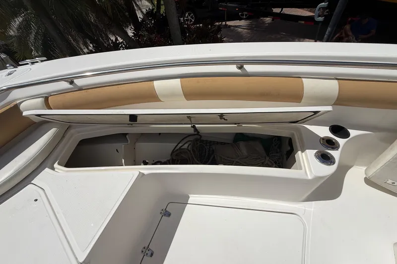 Slide: The Image of 2007 Boston Whaler 270 Outrage boat storage compartment with ropes and cup holders. - 80