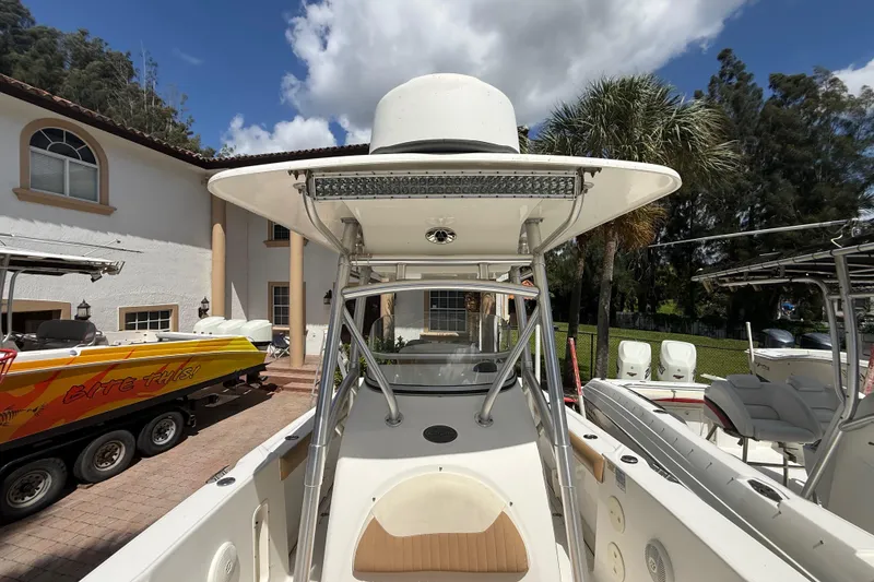 Slide: The Image of 2007 Boston Whaler 270 Outrage boat docked near a house with palm trees. - 84