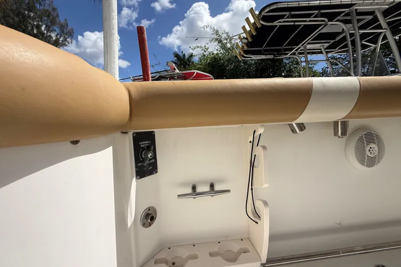 Slide: The Image of 2007 Boston Whaler 270 Outrage boat interior with livewell supply control and rod holders. - 86