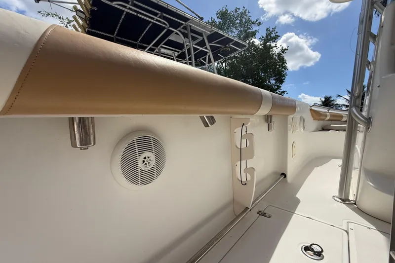 Slide: The Image of 2007 Boston Whaler 270 Outrage interior with padded railing and speaker. - 87