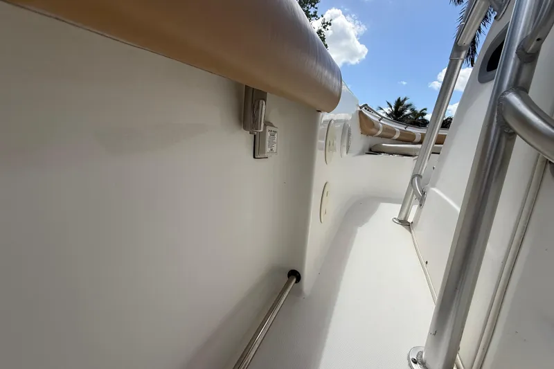 Slide: The Image of 2007 Boston Whaler 270 Outrage boat interior with stainless steel railings and cushioned seating. - 88