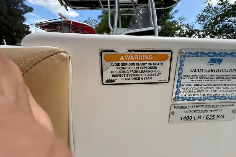 Slide: The Image of Warning and certification labels on a 2007 Boston Whaler 270 Outrage boat. - 90