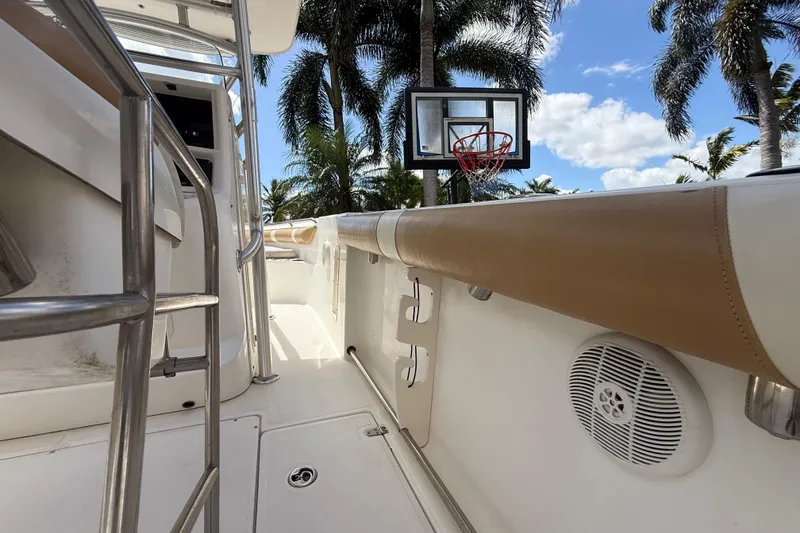 Slide: The Image of 2007 Boston Whaler 270 Outrage boat interior with basketball hoop and palm trees. - 94