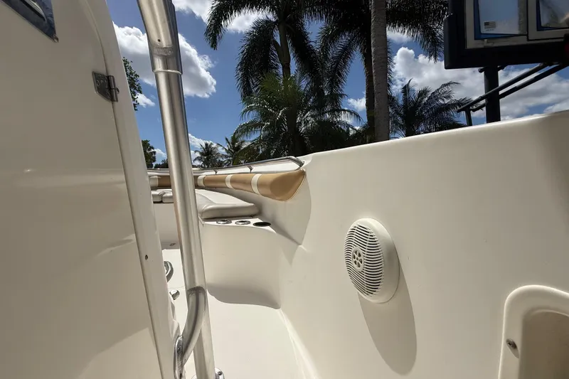 Slide: The Image of 2007 Boston Whaler 270 Outrage interior with speaker, palm trees in background. - 97