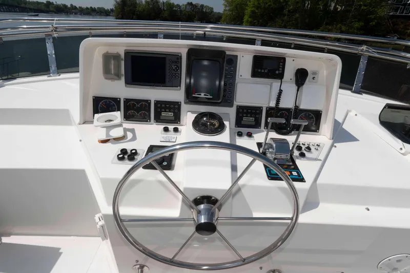 Slide: The Image of Side view of 1999 West Bay 58 Sonship Pilothouse MY docked by a wooden pier. - 12