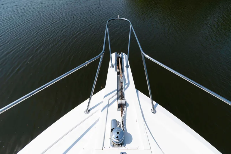 Slide: The Image of Bow view of 1999 West Bay 58 Sonship Pilothouse MY on calm water. - 16