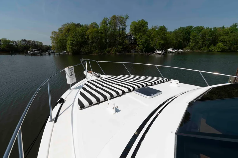 Slide: The Image of Luxurious interior of 1999 West Bay 58 Sonship Pilothouse MY with blue sofa and wooden accents. - 17