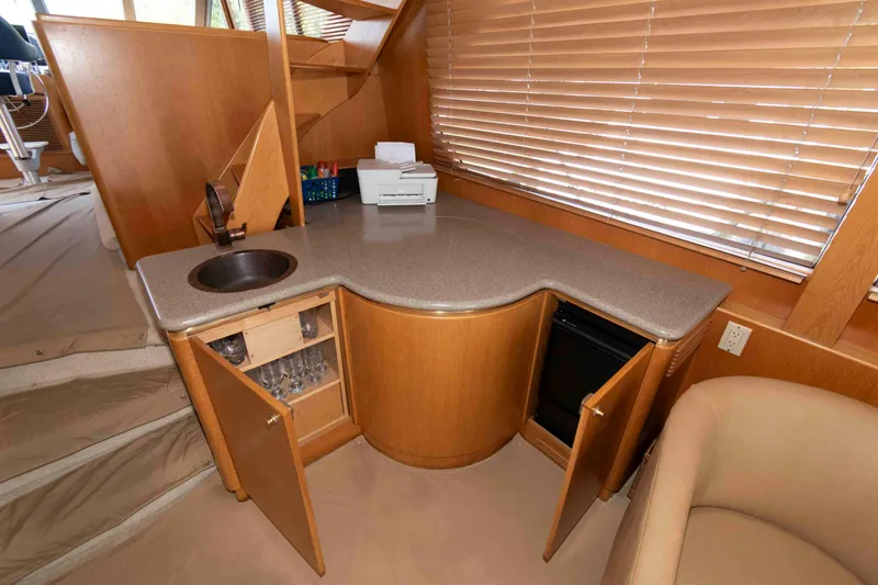 Slide: The Image of Interior of 1999 West Bay 58 Sonship Pilothouse MY with helm, seating, and kitchen area. - 21