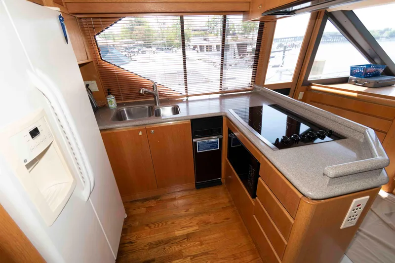 Slide: The Image of Interior of 1999 West Bay 58 Sonship Pilothouse MY with dining area and staircase. - 23