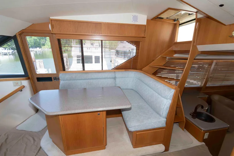 Slide: The Image of Pilothouse interior of 1999 West Bay 58 Sonship, featuring navigation controls and panoramic windows. - 24