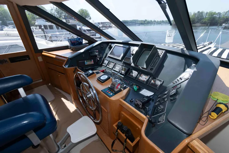 Slide: The Image of Cockpit view of 1999 West Bay 58 Sonship Pilothouse MY, showcasing navigation instruments. - 26