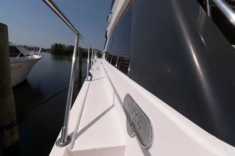 Slide: The Image of Spacious deck of 1999 West Bay 58 Sonship Pilothouse MY yacht at dock. - 3