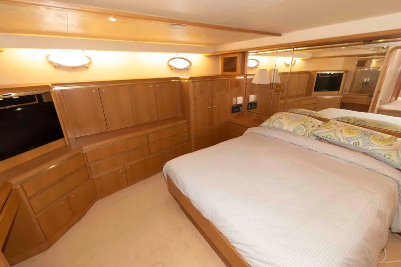 Slide: The Image of Luxurious bedroom in 1999 West Bay 58 Sonship Pilothouse yacht with elegant wood finishes. - 30