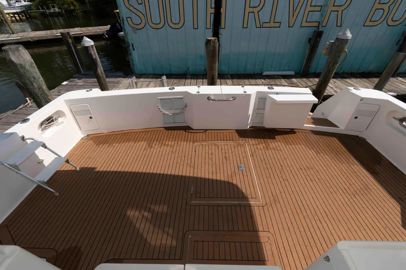Slide: The Image of 1999 West Bay 58 Sonship Pilothouse MY yacht deck with ladder and seating area. - 4