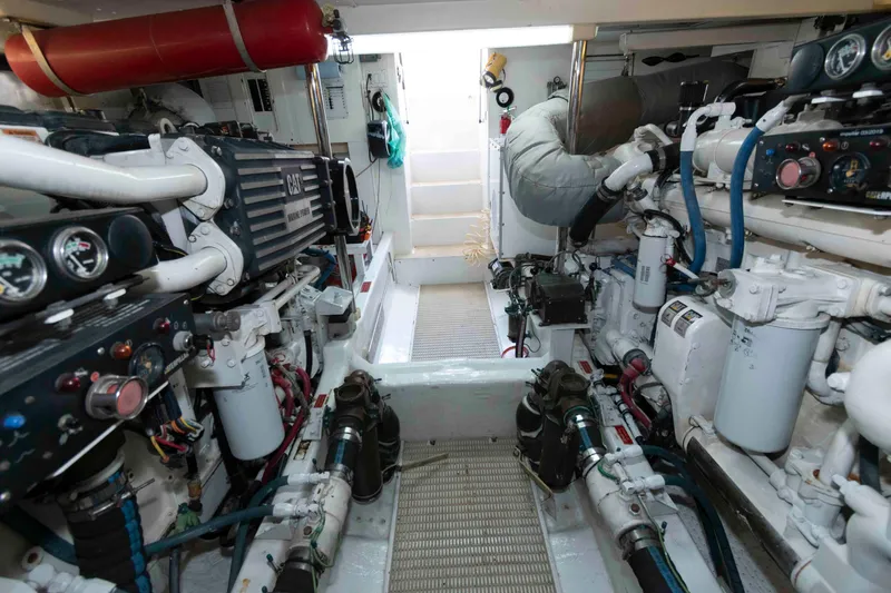 Slide: The Image of Engine room of 1999 West Bay 58 Sonship Pilothouse MY, showcasing dual engines and mechanical systems. - 40