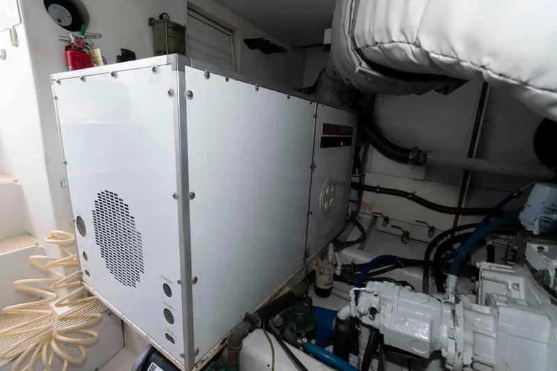 Slide: The Image of Engine room of 1999 West Bay 58 Sonship Pilothouse MY with mechanical equipment and ladder. - 44