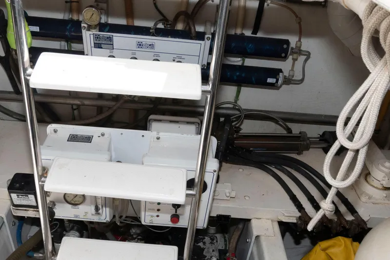 Slide: The Image of Engine room of 1999 West Bay 58 Sonship Pilothouse MY with control panels and equipment. - 45