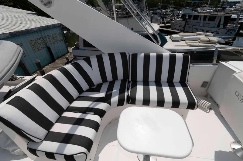 Slide: The Image of Luxurious 1999 West Bay 58 Sonship Pilothouse yacht with striped seating on deck. - 8